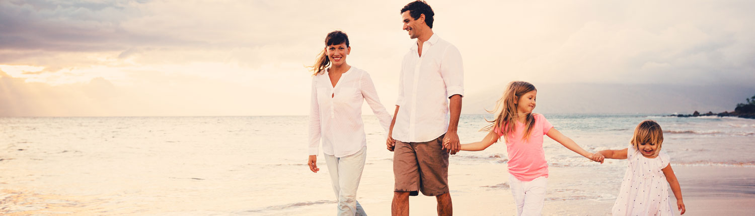 Young Family Walking on the Beach